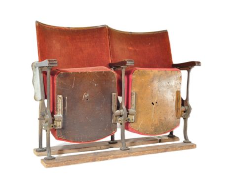 A pair of vintage 20th century&nbsp;cast iron cinema / theatre stall seats with seats and backs upholstered in red velvet, wi
