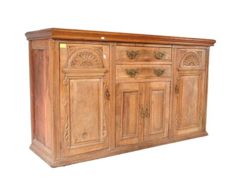 A late Victorian 19th century Arts &amp; Crafts oak sideboard credenza. Raised on plinth base with a series of cupboards and 