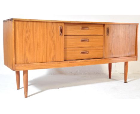 A retro vintage 20th century teak sideboard credenza having a central bank of three drawers flanked by sliding doors cupboard