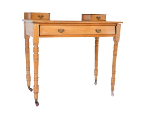 A late 19th century satin walnut writing table desk. Raised on ring turned legs with twin drawer frieze under flared top with