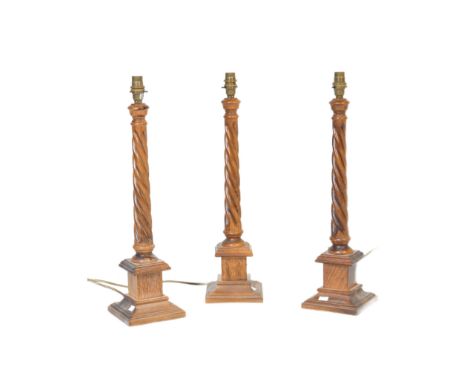 A collection of three vintage 20th Century matching oak wood lamp barley twist light bases. Having light fixing to top barley