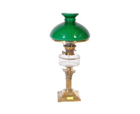 A 20th century brass oil lamp table lamp conversion. The lamp having globular green glass shade over moulded reservoir upon a