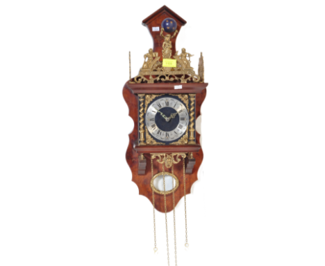 A 20th century reproduction 19th century Dutch wall clock having silvered face with roman numeral to chapter ring and brass s