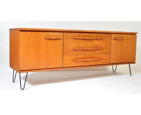 A retro vintage mid 20th Century teak wood sideboard / credenza. Of rectangular form with a bank of three drawers to centre f