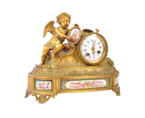 A late 19th century French 'Miroy' gilt metal &amp; porcelain mantel clock. The mantle clock having a figure of putto holding