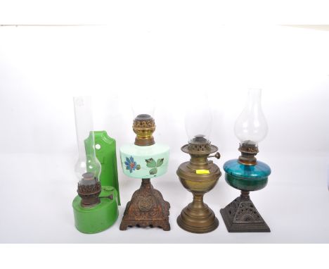 Oil lamps - A collection of three vintage 20th Century oil lamps lights. Two with flute glass shades with cast iron bass and 