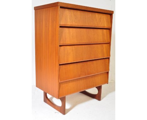 A retro vintage mid 20th century circa. 1960's teak beehive chest of drawers having a bank of four drawers raised over quadri