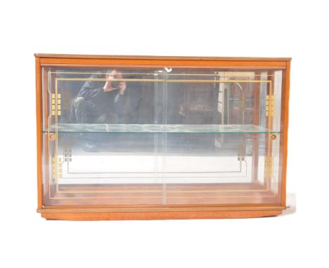 A retro vintage mid 20th century teak &amp; glass display cabinet. The cabinet having a straight top over glass sliding doors