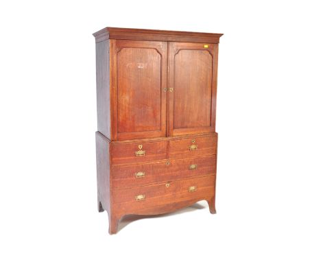 A 19th century George III mahogany linen press. The linen press being raised on bracket feet with a series of drawers under l
