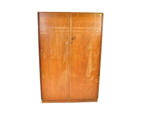 A vintage early 20th Century circa 1930s double wardrobe. Of rectangular form with twin cupboard doors opening to reveal a sh