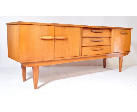 A retro vintage mid 20th century teak sideboard credenza having a central bank of three drawers flanked by single door cupboa