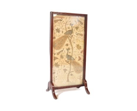 A 19th Century Victorian fire screen discretion panel, the silk panel embroidered in gilt and silver thread depicting peacock