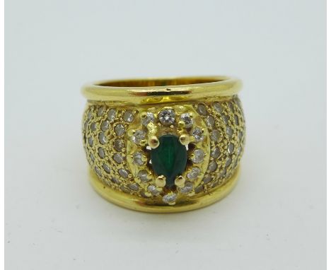 An 18ct gold, green stone and diamond ring, lacking one diamond, marked 750, 13.1g, N