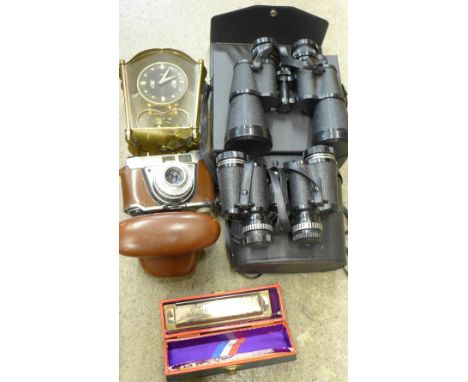 A Schatz brass and glass sided clock, a Super Chromonica harmonica, cased, two pairs of binoculars, cased and a Kodak camera