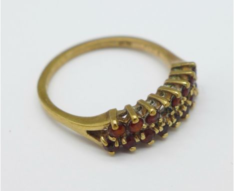 A 9ct gold and garnet ring, 2g, N, a/f, lacking one stone