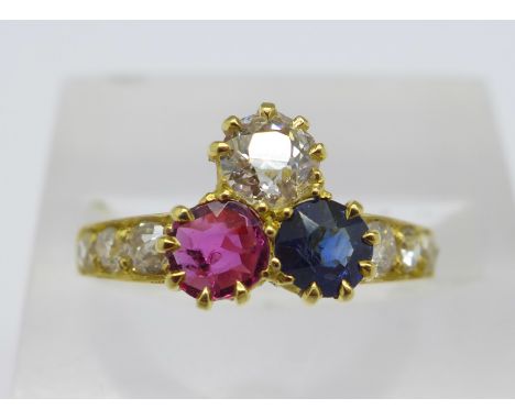 An 18ct gold, diamond, ruby and sapphire ring, the shoulders set with six other diamonds, the main diamond approximately 0.5 