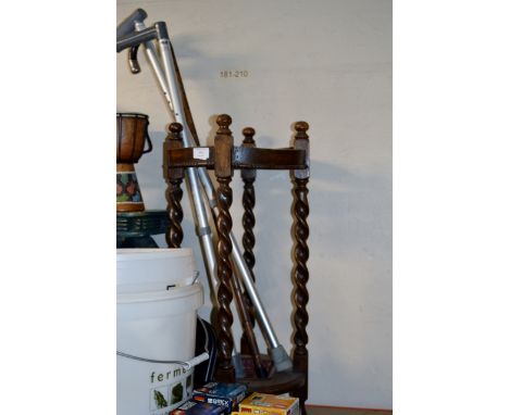 AN OAK STICK STAND WITH 1 SILVER MOUNTED STICK &amp; 2 OTHER STICKS     