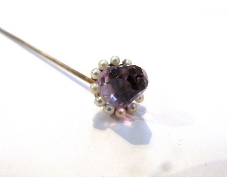 A seed pearl and amethyst stick pin with moveable head