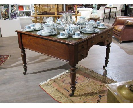 A circa 1840 mahogany partners desk, the gilt tooled leather writing surface over ten drawers on turned legs and ceramic cast