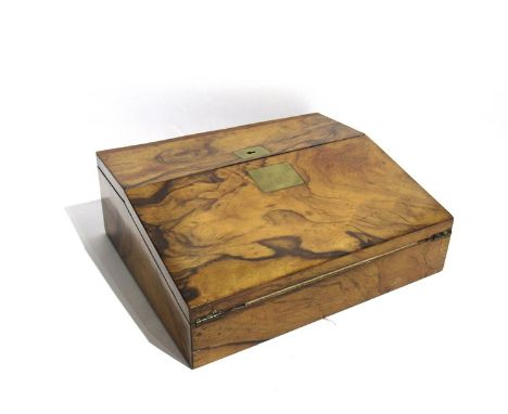 A 19th Century walnut writing slope of interesting form, the top panel opening to reveal a fitted inkwell and pen tray, 11cm 