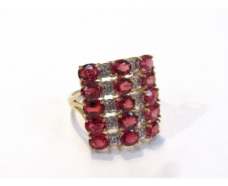 A 9ct gold dress ring, three rows of rubies and two rows of diamond chip in large square mount, size N/O, 5.3g