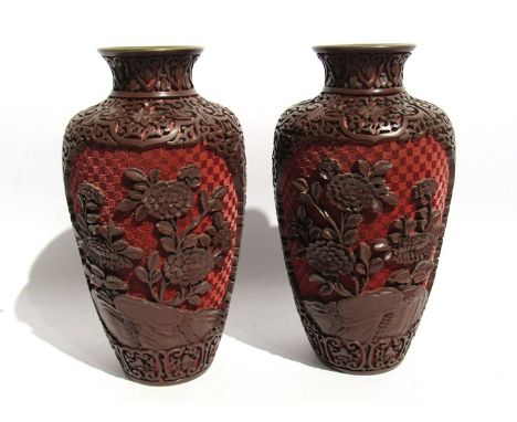 A pair of Chinese two tone red cinnabar lacquer vases decorated with flowers, blue enamel interior, 23cm tall