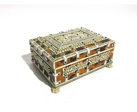 A 19th Century Indian tortoiseshell and ivory segmented trinket box with lion cartouche, a/f, foot missing, 7cm x 15.5cm x 11