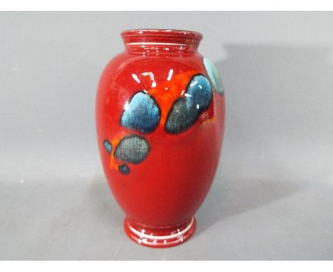 Poole Pottery - A Poole Pottery ceramic vase with abstract design on a red ground, approximately 20 cm (h)