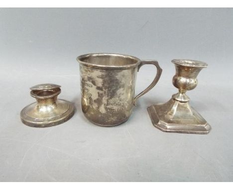 A small collection of silver hallmarked items comprising a small capstan inkwell Chester assay 1912, a dwarf candlestick, Bir