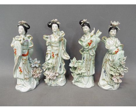 Four Chinese ceramic figurines depicting ladies with flowers, approximately 22 cm (h). [4]
