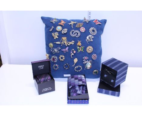 A selection of vintage brooches and boxed tie gift sets 