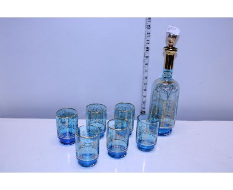 A vintage blue and gilt decanter with six glasses 