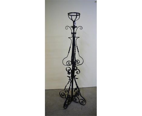 A wrought iron oil lamp stand