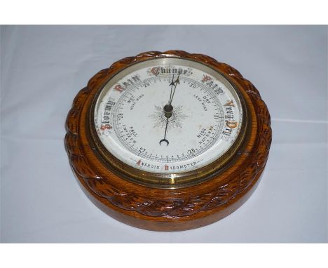 Late 19th century oak android barometer with rope twist decoration