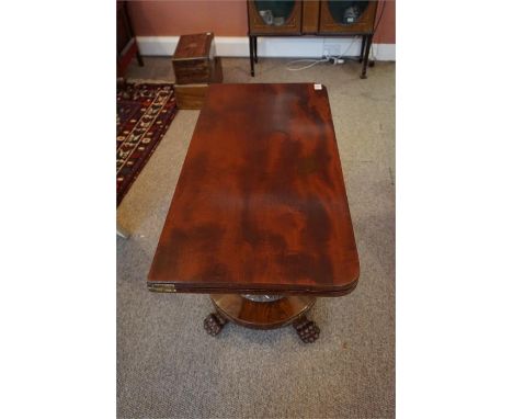 19th Century turn over top mahogany card table, with carved centre column circular platform base standing on carved paw feet