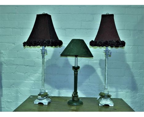 A pair of painted metal candlestick lamps and a wooden green painted candlestick lamp