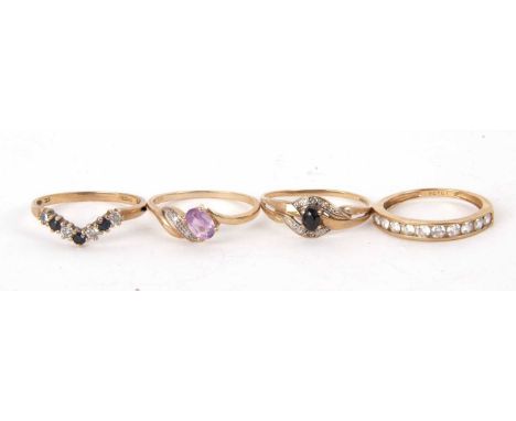 Four 9ct gemset rings, to include a 9ct sapphire and white stone ring, an amethyst ring, a sapphire crossover ring and a CZ h