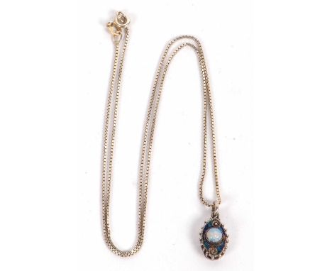 A silver pendant by Charles Horner, the oval silver pendant with blue enamel and faux moonstone, with beaded border, approx. 