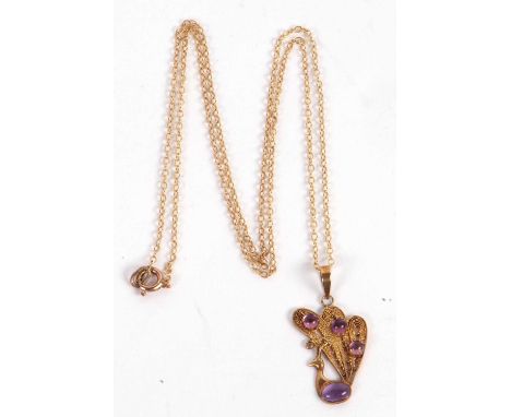An amethyst peacock pendant, the filgree peacock set with four amethyst cabochons, unmarked, with bale stamped '925 S', 3cm, 