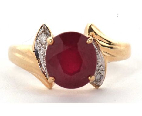 A 14k ruby and diamond ring, round ruby, approx. 8.8mm diameter, in a four claw mount, with a teardrop shape of white metal s