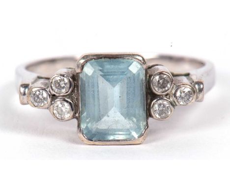 An aquamarine and diamond ring, the mixed cut rectangular emerald, collet mounted with three small round brilliant cut diamon