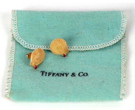 A pair of 14k Tiffany and ruby shell earrings, the naturalistic shells, each set with a small round ruby, stamped 14k to reve