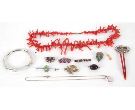 A mixed lot of jewellery to include a jade bangle with silver mounts, a coral branch necklace, paste brooches, paste set hair