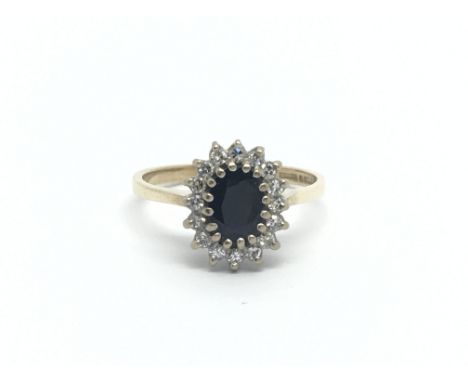 A 9carat gold ring set with a sapphire and small diamonds ring size M.