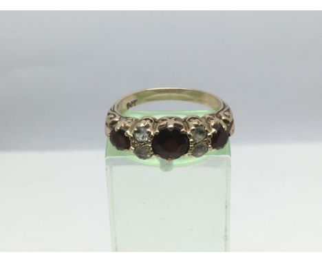 A 9ct gold ring set with garnets, approx 3.2g and approx size M.