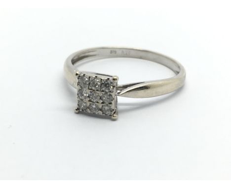 A 9ct white gold nine stone diamond ring, approx .20ct, approx 1.8g and approx size R.