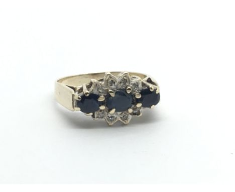 A 9carat gold ring set with three sapphire and chip stone diamonds ring size J.