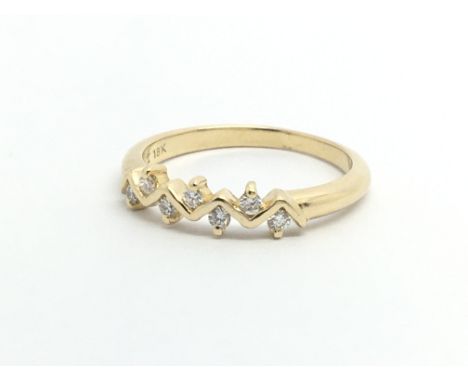 An 18ct gold ring set with seven small diamonds, approx .10ct, approx 2.5g and approx size K-L.