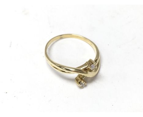 An 18ct gold and 2 diamond crossover ring (unmarked but tested).