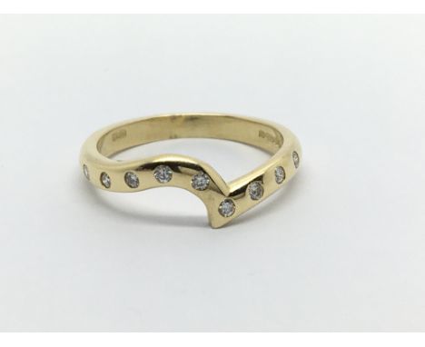 An 18ct gold wishbone ring set with nine small diamonds, approx 2.7g and approx size J-K.